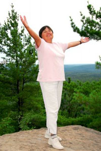 Woman celebrating her recovery after suffering a debilitating condition Woman celebrating her recovery after suffering a debilitating condition