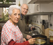 Elderly man and woman cooking together Elderly man and woman cooking together